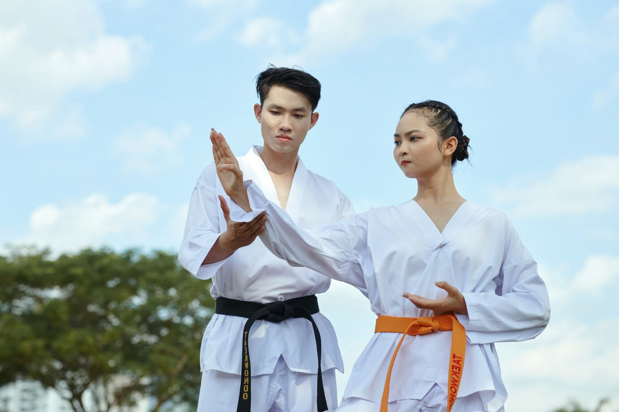 Taekwondo Instructor Working with Girl